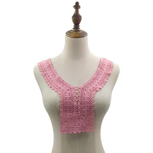 Detail of pink water-soluble lace collar with intricate embroidery on a mannequin