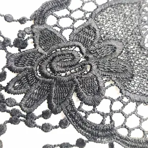 Macro details of black water-soluble lace applique embroidery