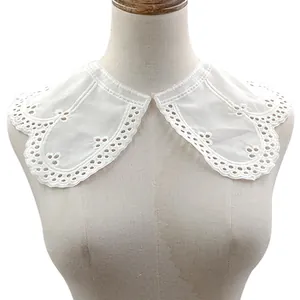 Detailed view of a white cotton embroidered eyelet lace collar accessory on a mannequin