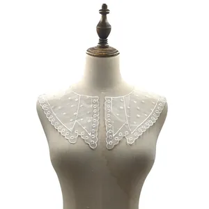Detail view of white lace organza embroidered collar with polka dots on a mannequin