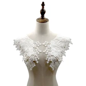 Detailed view of white cotton embroidered lace collar patches displayed on a mannequin