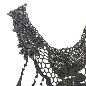Detailed macro view of black water-soluble embroidery lace collar neckline applique