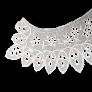 Close-up of intricate white cotton eyelet embroidery lace collar with floral pattern