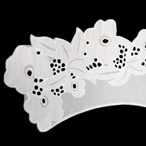 Close-up of white cotton embroidered lace collar with intricate floral patterns