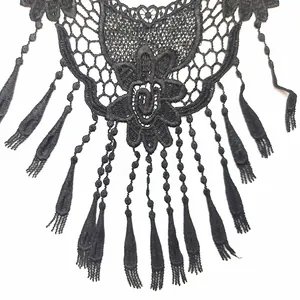 Exquisite detail of black water-soluble lace collar with 3D floral embroidery and tassels