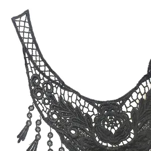 Detailed macro view of black water-soluble lace collar with 3D floral embroidery.