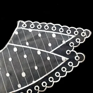 Detailed view of white embroidered organza lace collar with scallop edge and dotted pattern