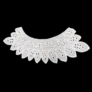 Close-up of white cotton embroidered detachable collar with eyelet lace details.