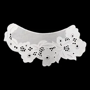 Detailed view of white cotton embroidered lace collar with flower patterns