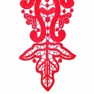 Detail macro view of bright red water-soluble lace collar applique for DIY sewing project.