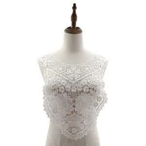 Detail showing the intricate floral embroidery of the water-soluble lace collar