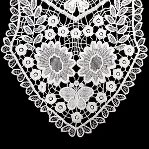 Detail view of white water-soluble lace collar with floral and butterfly patterns