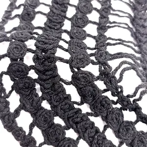 Close-up view of black coarse cotton embroidered hollow lace crochet flower pattern