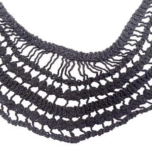 Close-up of black coarse cotton hollow lace collar with intricate crochet texture