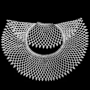 Detailed view of white water-soluble lace collar with delicate hollow embroidery pattern.