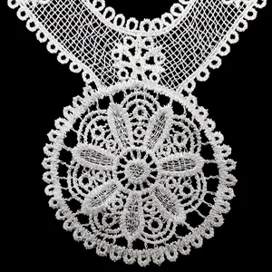 Close-up of white water-soluble lace collar with intricate floral embroidery detail