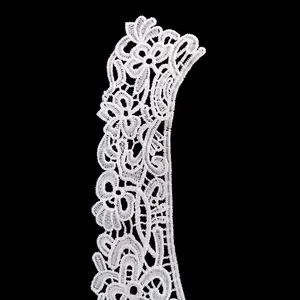 Detailed view of white water-soluble lace collar with delicate floral embroidery