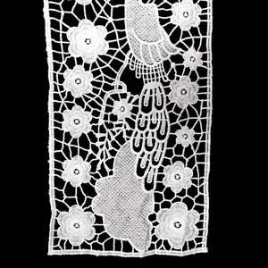Macro view of intricate white milk silk lace collar with peacock and floral embroidery detail