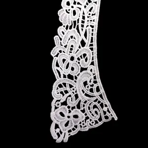 Close-up of intricate white water-soluble lace collar with floral embroidery