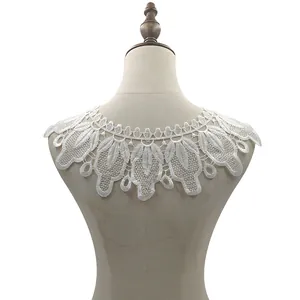 Close-up detail of white water-soluble lace collar applique shown on a mannequin torso