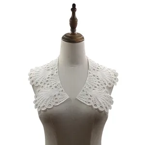 Detailed view of elegant white hollow lace embroidered fake collar on a dress form