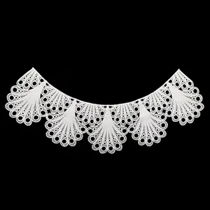 Detailed view of white water-soluble lace embroidered collar with intricate fan patterns