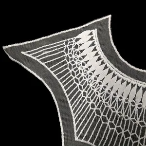 Close-up macro detail of white milk silk embroidered lace collar on black background