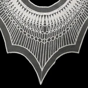 Detailed macro view of white water-soluble lace embroidered fake collar with geometric pattern