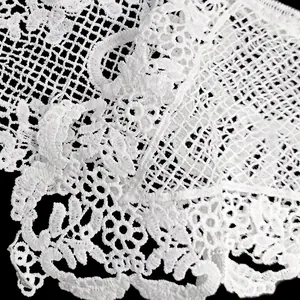 Detailed close-up view showing the intricate texture of white water-soluble embroidered lace