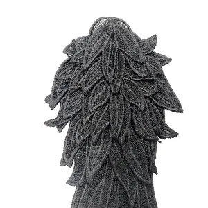 Detailed macro view of black layered embroidered angel wing lace applique texture