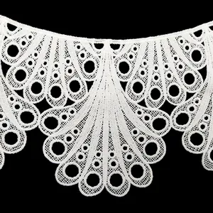Detailed close-up of white water-soluble lace collar with delicate peacock embroidery