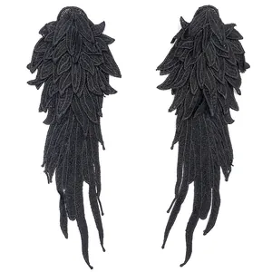 Detailed macro view of black multi-layered embroidered lace wing patches for DIY crafts