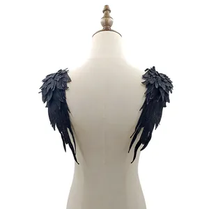 Detailed view of heavy-duty black angel wing lace embroidery patches on mannequin.