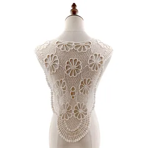 Detailed macro view of cream white cotton lace embroidered false collar with floral hollow design