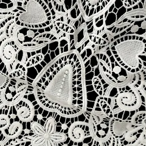 Detailed macro view of white water-soluble milk silk heart lace embroidery