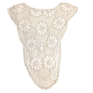 Close-up view of intricate cream white floral crochet lace applique for DIY sewing projects