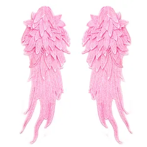 Detailed view of pink multi-layered angel wing embroidered lace patches for DIY crafts.