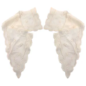 Detailed view of a white embroidered cotton faux collar with eyelet lace trim.