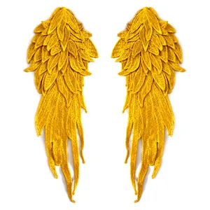 Detail view of yellow embroidered angel wing patches with multi-layered lace texture