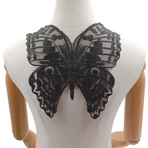 Detail showing intricate silver-black butterfly embroidery on water-soluble mesh