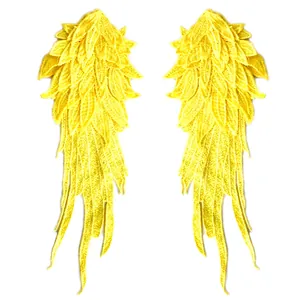 Intricate yellow angel wing lace patches with detailed multi-layer embroidery texture.