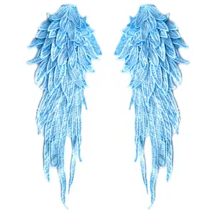 Macro view of blue embroidered angel wings patches with intricate layered lace details