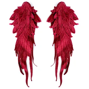 Detailed view of multi-layered red embroidered angel wing lace applique patches
