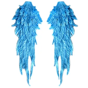 Detailed view of sky blue embroidered angel wing lace patches with heavy textures