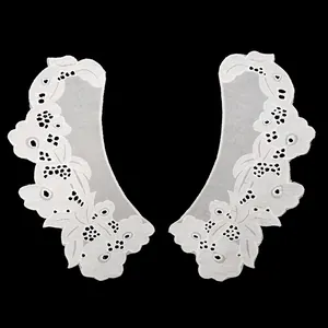 Close-up of white cotton embroidered faux collar with intricate hollow-out floral lace detail