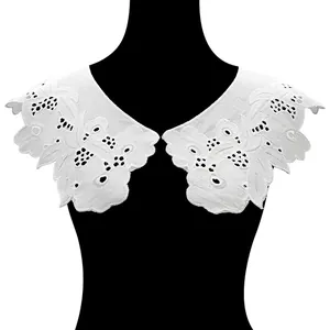 Detailed view of white embroidered cotton detachable collar with hollow-out pattern
