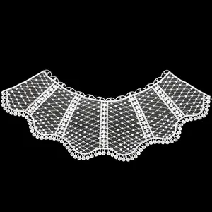 Detail view of white water-soluble lace embroidered detachable collar on black background