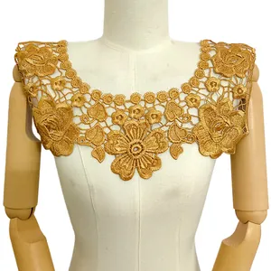 Detail of gold 3D hollow floral embroidery on a white mannequin collar
