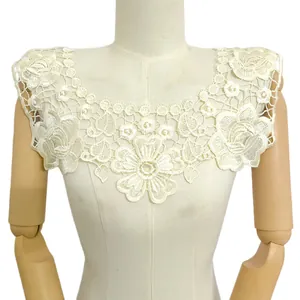 Detailed view of a white 3D floral embroidered lace collar accessory on a mannequin.