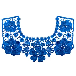 Macro detail view of intricate blue floral lace embroidery collar with hollow-out pattern